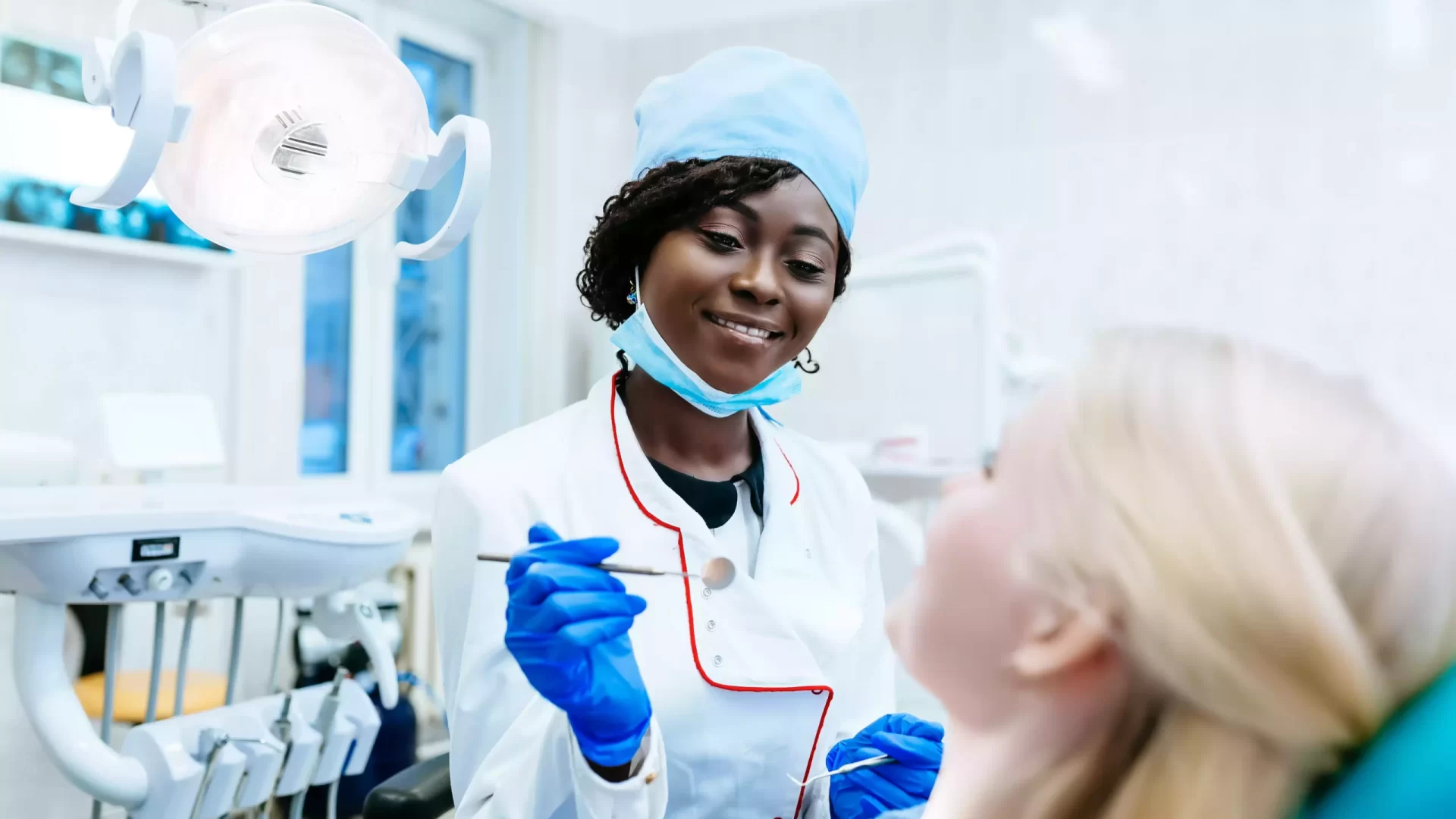 african-american-female-dentist-treating-patient-a-2023-11-27-05-03-58-utc-min